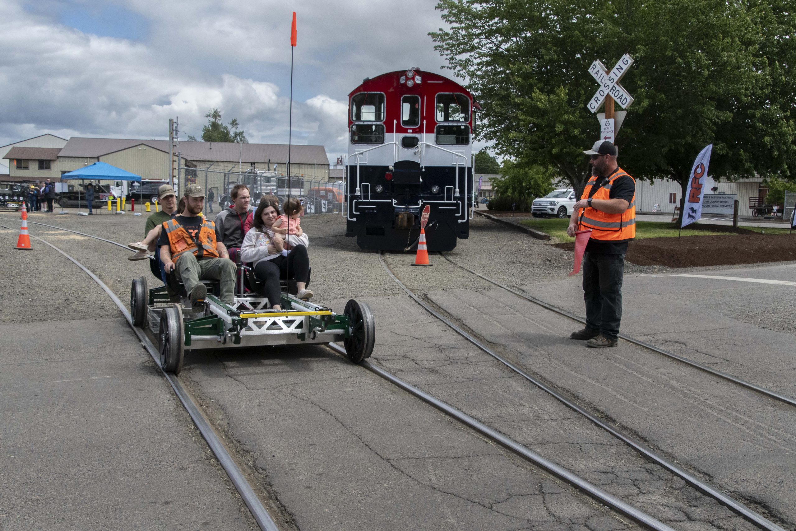 Family riding a hand-pumped rail cart along the track