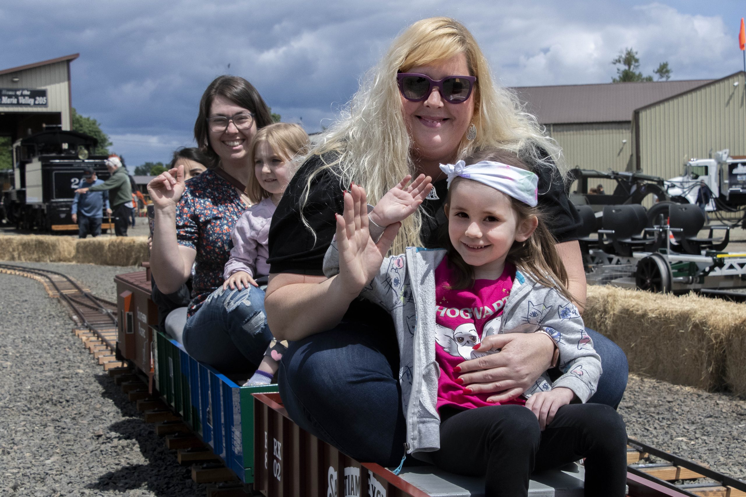 Mother and daughter waving at the Steel & Steam event